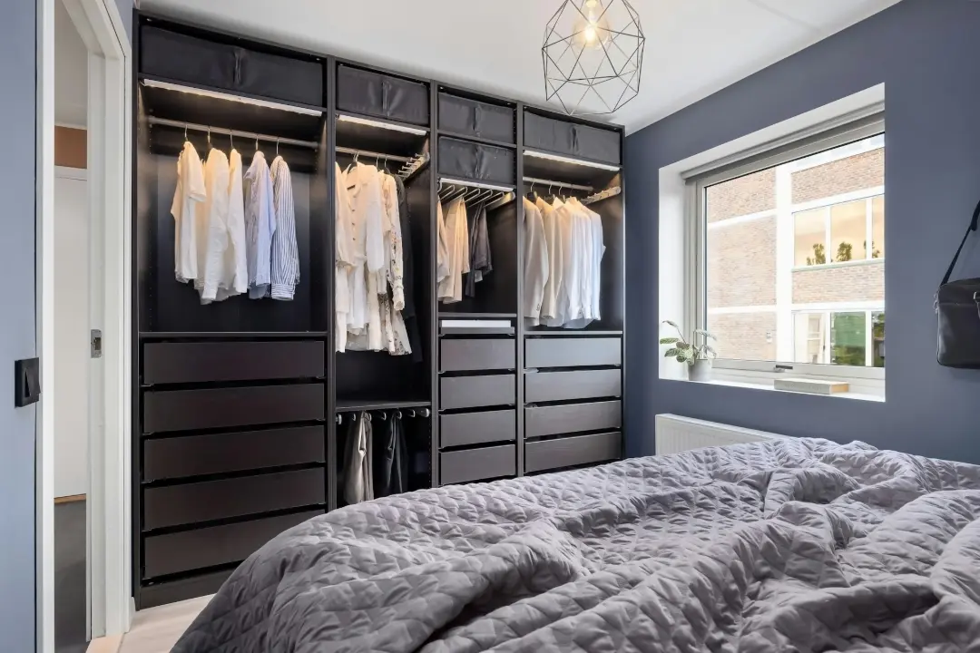 A bedroom with a bed and a closet