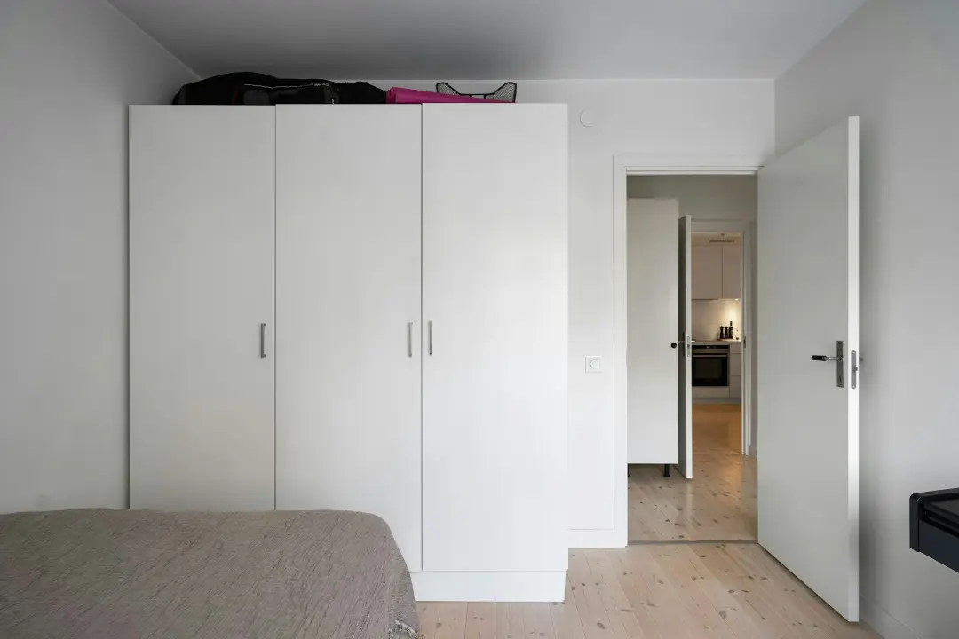 A bedroom with a bed and a closet