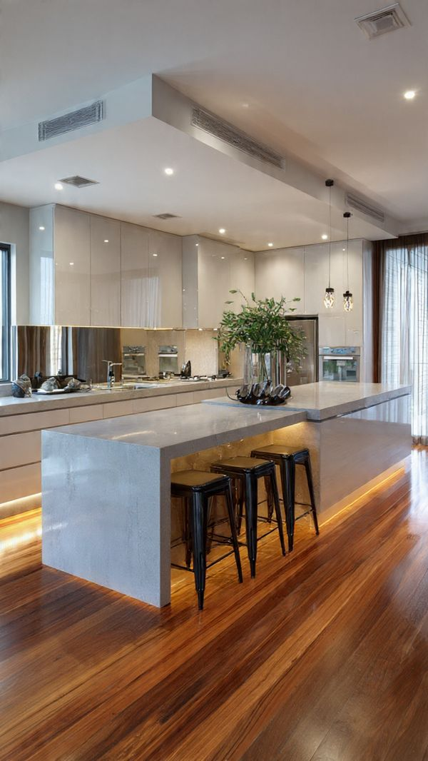 Stylish island kitchen with high-gloss acrylic cabinets and integrated lighting